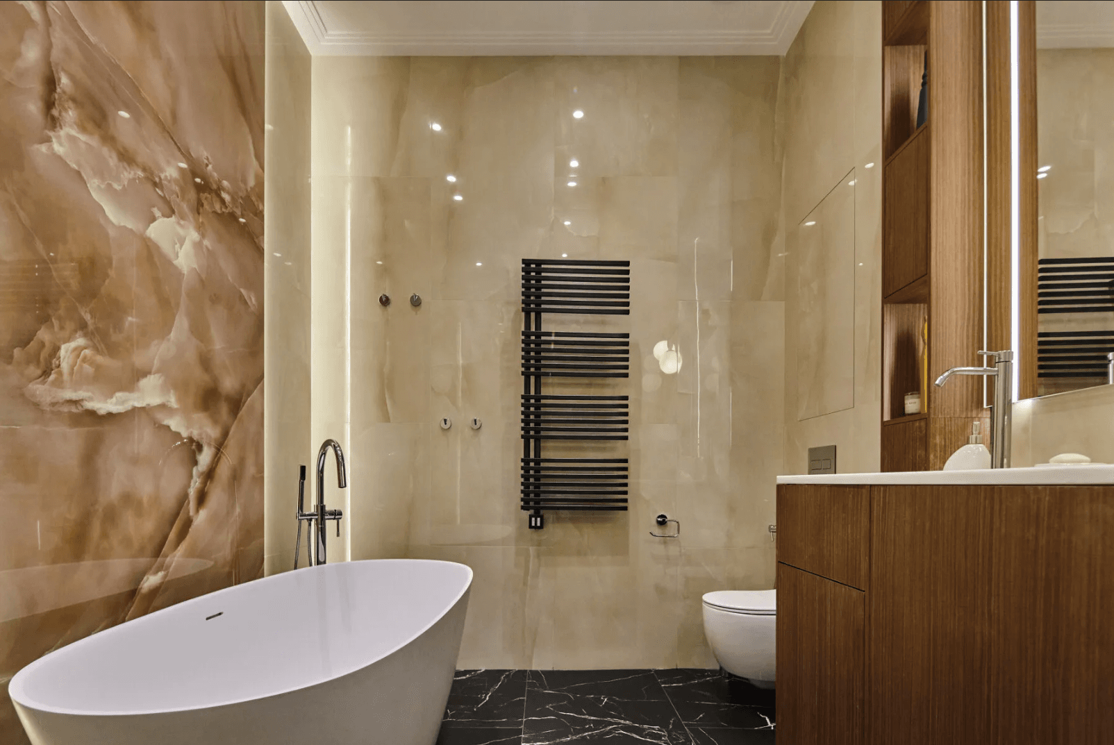 Luxury bathroom with onyx walls, freestanding white tub and wood vanity